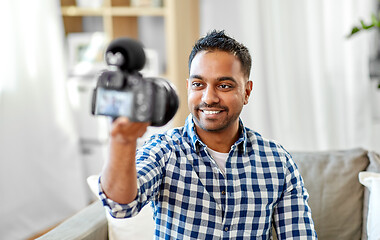 Image showing male video blogger with camera blogging at home