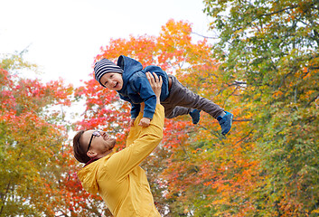 Image showing father with son playing and having fun in autumn