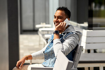 Image showing indian man calling on smartphone at street cafe