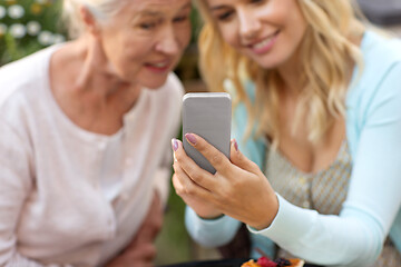 Image showing daughter and senior mother taking selfie at park