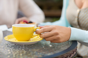 Image showing hand of woman drinking tea at outdoor cafe