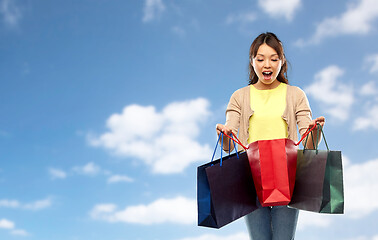 Image showing happy asian woman with shopping bags