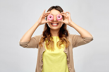 Image showing happy asian woman with eyes of donuts