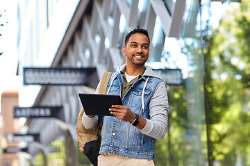 Image showing man with tablet pc and backpack on city street