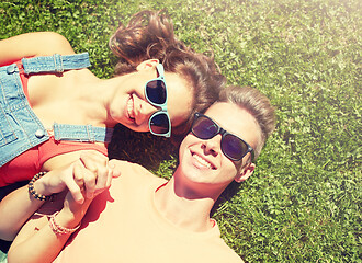 Image showing happy teenage couple lying on grass at summer