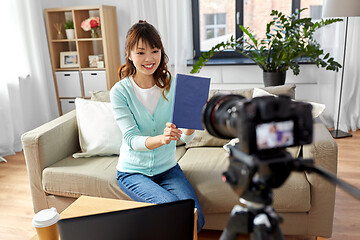 Image showing asian female blogger making video review of book