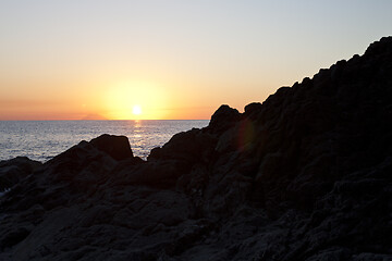 Image showing Sunset on the rocky shore. Tyrrhenian Sea.