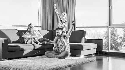 Image showing Happy family playing a video game