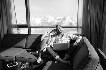 Image showing couple relaxing at  home using laptop computers