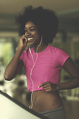 Image showing afro american woman running on a treadmill