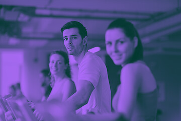 Image showing Group of people running on treadmills