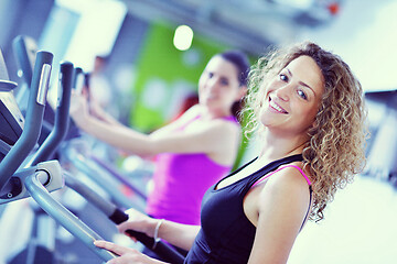 Image showing Group of people running on treadmills