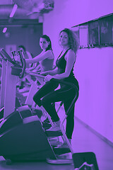 Image showing Group of people running on treadmills