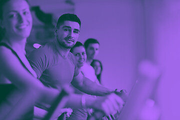 Image showing Group of people running on treadmills