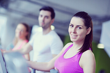 Image showing Group of people running on treadmills