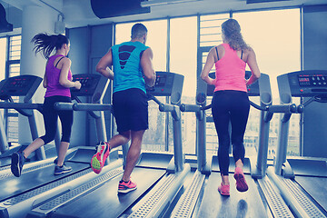 Image showing Group of people running on treadmills