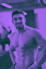 Image showing handsome man exercising at the gym