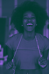 Image showing afro american woman running on a treadmill