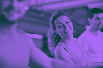 Image showing Group of people running on treadmills