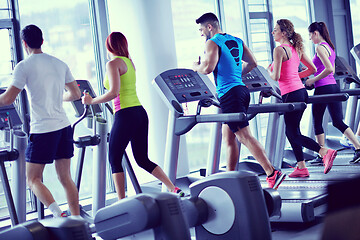 Image showing Group of people running on treadmills