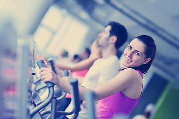 Image showing Group of people running on treadmills