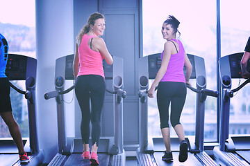 Image showing Group of people running on treadmills