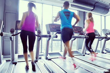 Image showing Group of people running on treadmills