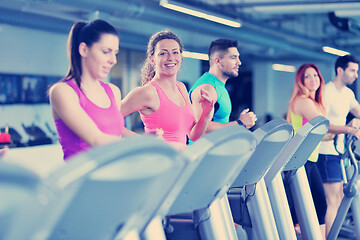 Image showing Group of people running on treadmills