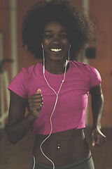 Image showing afro american woman running on a treadmill