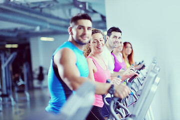 Image showing Group of people running on treadmills