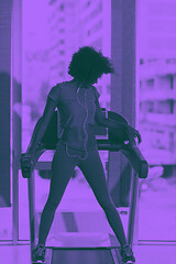 Image showing afro american woman running on a treadmill