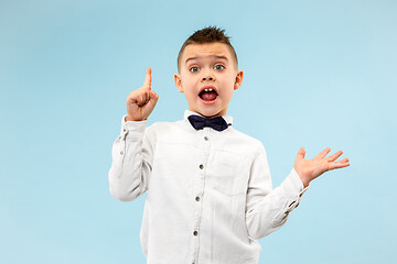 Image showing The young attractive teen boy looking suprised isolated on blue