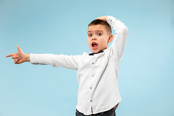 Image showing The young attractive teen boy looking suprised isolated on blue