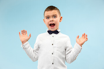 Image showing The young attractive teen boy looking suprised isolated on blue