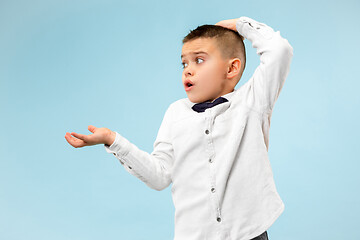 Image showing Beautiful teen boy looking suprised and bewildered isolated on blue