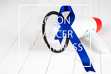 Image showing Colon cancer awareness poster. Blue ribbon made of dots on white background. Medical concept.
