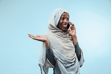 Image showing The beautiful young black muslim girl wearing gray hijab, with a happy smile on her face.