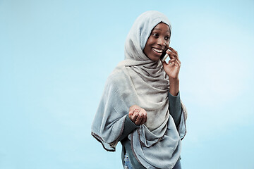 Image showing The beautiful young black muslim girl wearing gray hijab, with a happy smile on her face.
