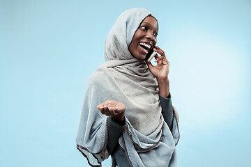 Image showing The beautiful young black muslim girl wearing gray hijab, with a happy smile on her face.