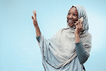 Image showing The beautiful young black muslim girl wearing gray hijab, with a happy smile on her face.