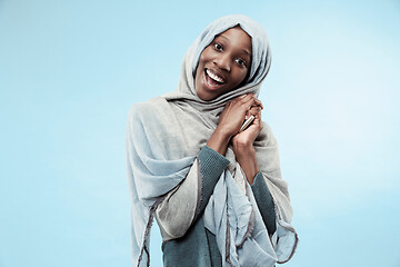 Image showing The beautiful young black muslim girl wearing gray hijab, with a happy smile on her face.