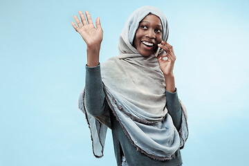 Image showing The beautiful young black muslim girl wearing gray hijab, with a happy smile on her face.