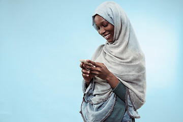 Image showing The beautiful young black muslim girl wearing gray hijab, with a happy smile on her face.