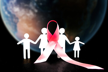 Image showing The composition with pink ribbon on a table background