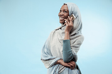 Image showing The beautiful young black muslim girl wearing gray hijab, with a happy smile on her face.