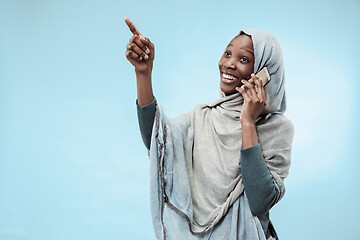 Image showing The beautiful young black muslim girl wearing gray hijab, with a happy smile on her face.