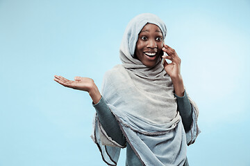 Image showing The beautiful young black muslim girl wearing gray hijab, with a happy smile on her face.