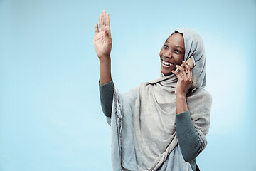 Image showing The beautiful young black muslim girl wearing gray hijab, with a happy smile on her face.