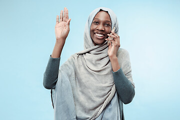 Image showing The beautiful young black muslim girl wearing gray hijab, with a happy smile on her face.