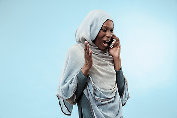 Image showing The beautiful young black muslim girl wearing gray hijab, with a happy smile on her face.